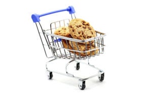 A supermarket trolley or shopping cart with chocolate cookies
