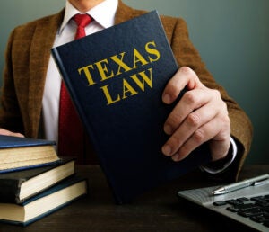 The lawyer offers a book withTexas law.